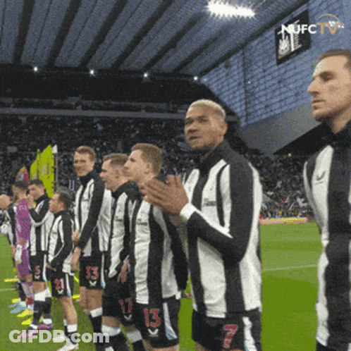 Soccer Players Wearing Black And White Striped Jerseys GIF