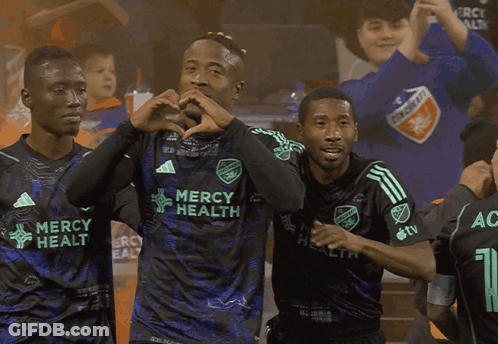 Soccer Players Wearing Mercy Health Jerseys Are Celebrating A Goal GIF