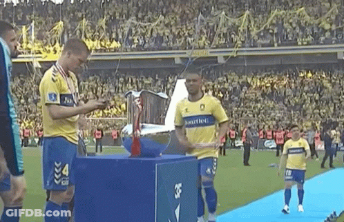 Soccer Players With Trophy Number 4 GIF