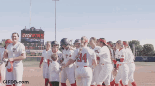 Softball Players In Front Of Tech Wins Sign GIF