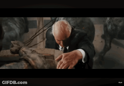 Soldier Holding Another Man In Dark Room GIF