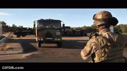 Soldier In Front Of Military Truck With LC License Plate GIF
