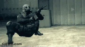 Soldier In Gas Mask Holding Gun In Building GIF