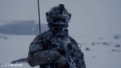 Soldier In Helmet And Goggles Holding Gun In Snow GIF