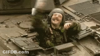 Soldier Sitting On Tank With Helmet GIF