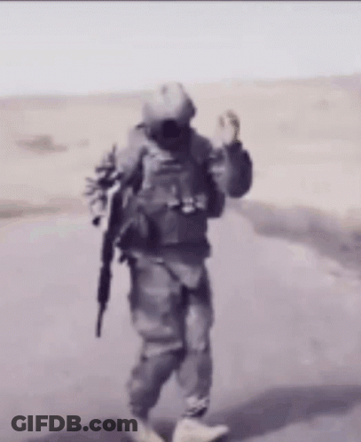 Soldier Walking Down Road With Gun GIF