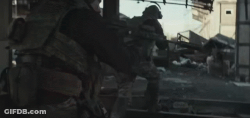Soldier Walking Through Destroyed City With Gun GIF