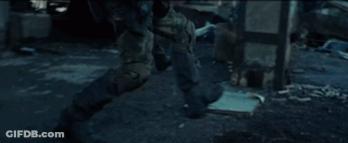 Soldier Walking Through Ruined Building With Gun GIF