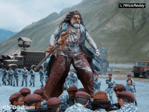 Soldiers Around Statue Of 7Wick Reddy GIF
