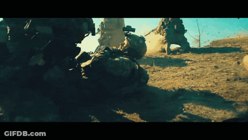 Soldiers Fighting In Dirt With One Laying Down GIF