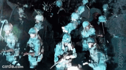 Soldiers Gathered In Dark Room With Number 022 GIF