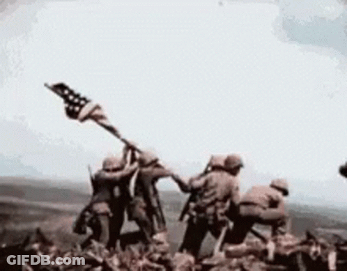 Soldiers Holding American Flag On Mountain GIF