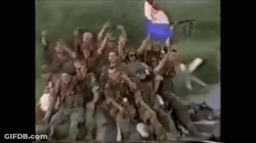 Soldiers In Field With Hands Up GIF