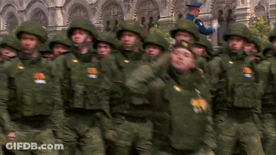 Soldiers In Green Uniforms Saluting In Front Of Old Building GIF