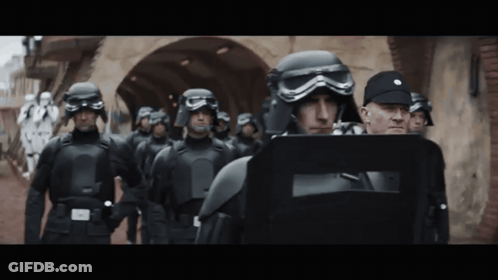 Soldiers In Helmets And Goggles Walking Down Street GIF