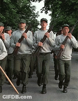 Soldiers Marching Down Street Holding Guns GIF