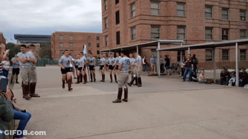 Soldiers Marching In Front Of Building Number 16 GIF