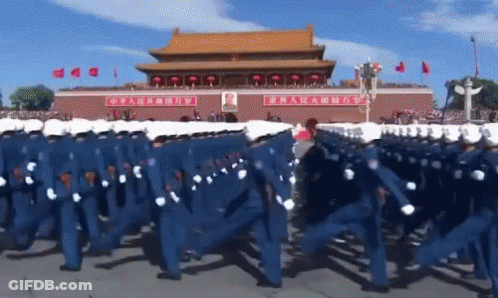 Soldiers Marching In Front Of Building With Chinese Writing GIF