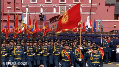 Soldiers Marching In Front Of Building With Portrait GIF