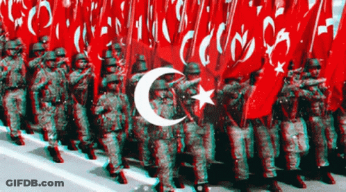 Soldiers Marching In Front Of Crescent Moon And Star Flag GIF