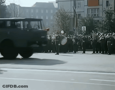 Soldiers Marching With Sign Saying A GIF