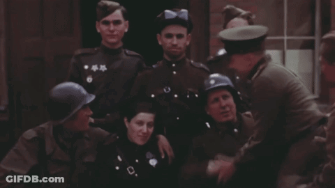 Soldiers Posing With One In Blue Helmet GIF