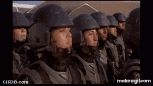 Soldiers Standing In A Row With Helmets And Armor GIF