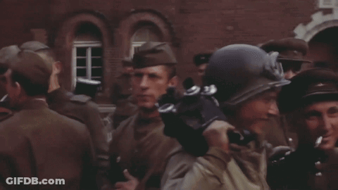 Soldiers Standing In Front Of Building With Helmet And Goggles GIF
