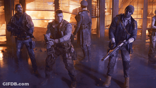 Soldiers Standing In Front Of Burning Building GIF