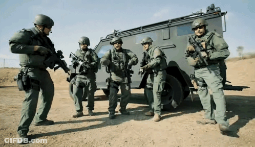 Soldiers Standing In Front Of Military Vehicle GIF