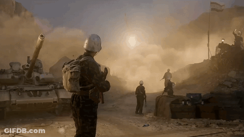 Soldiers Standing In Front Of Tanks GIF