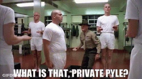 Soldiers Standing In Locker Room With Soldier Kneeling GIF