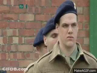 Soldiers Standing In Row In Front Of Building GIF