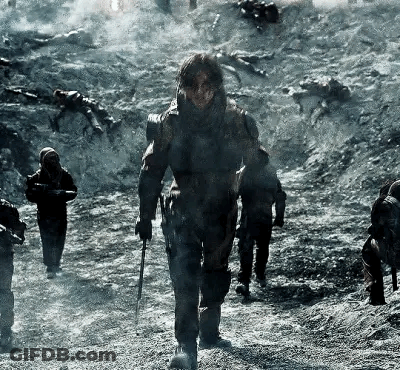 Soldiers Walking Down Dirt Road Holding Guns GIF