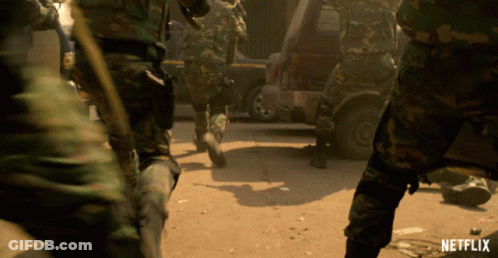 Soldiers Walking Down Dirt Road With Netflix Logo GIF
