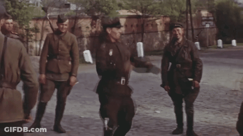 Soldiers Walking Down Street With Letter D On Uniform GIF