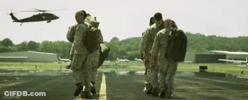 Soldiers Walking On Runway With Helicopter GIF