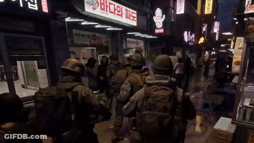 Soldiers Walking Past Store Saying Squid GIF