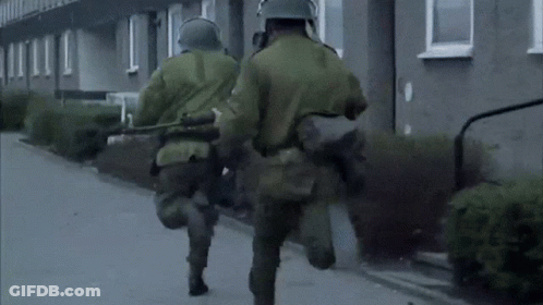 Soldiers Wearing Gas Masks And Helmets Walking GIF