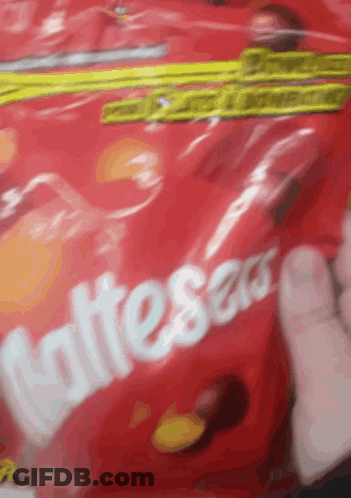 Someone Holding Bag Of Skittles Candy GIF