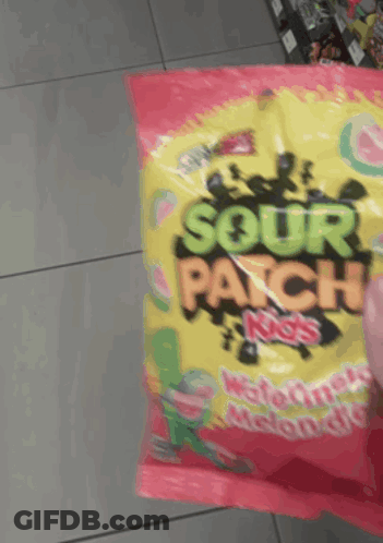 Someone Is Holding A Bag Of Sour Patch Kids Watermelon Flavored Candy GIF