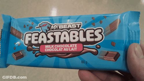 Someone Is Holding A Bar Of Mr Beast Feastables GIF
