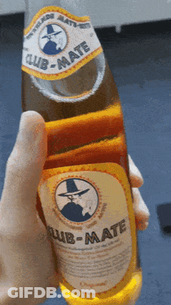 Someone Is Holding A Bottle Of Club-Mate In Their Hand GIF