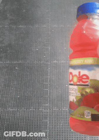 Someone Is Holding A Bottle Of Dole Strawberry Juice GIF