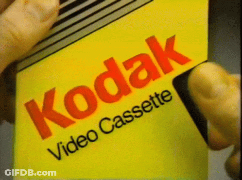 Someone Is Holding A Kodak Video Cassette GIF