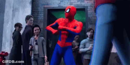 Spider-Man Is Flexing His Muscles In Front Of A Group Of People In A Crowd . GIF