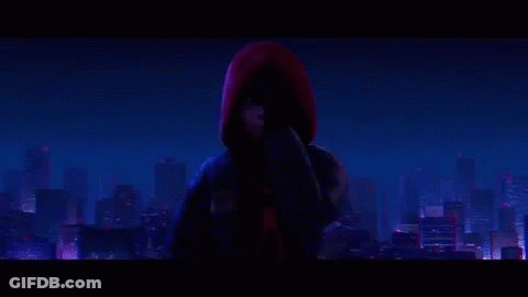 Spider-Man Is Standing In Front Of A City At Night . GIF
