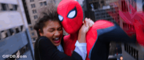 Spiderman Costume Hugging Woman In Suit GIF