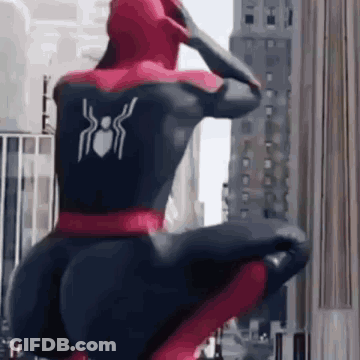 Spiderman Squatting In Front Of City Building GIF