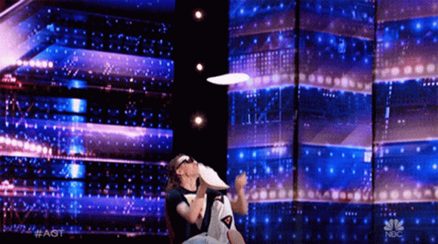Spinning Juggling Pizza On Stage GIF